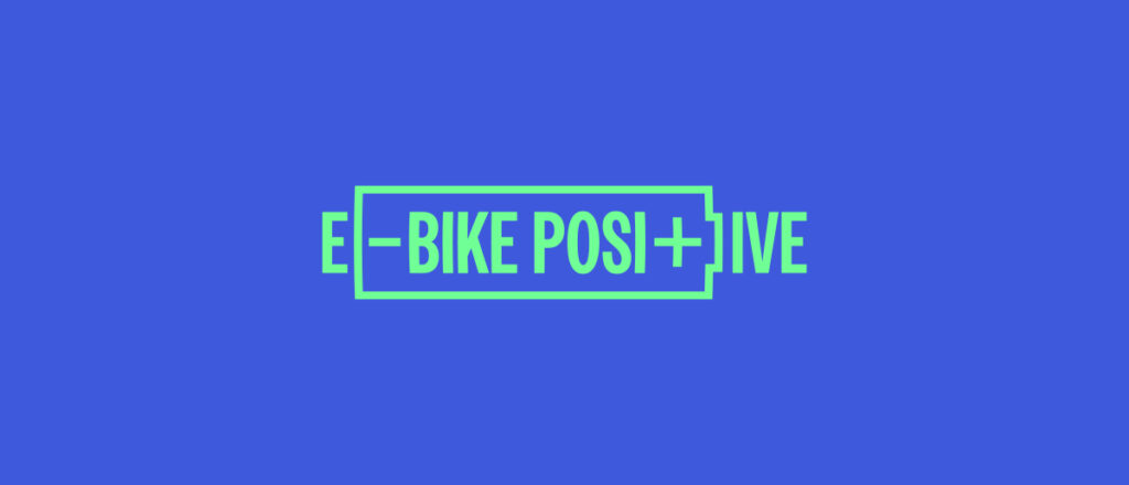The e-bike positive campaign logo in  bright green in centre of image on a bright blue background