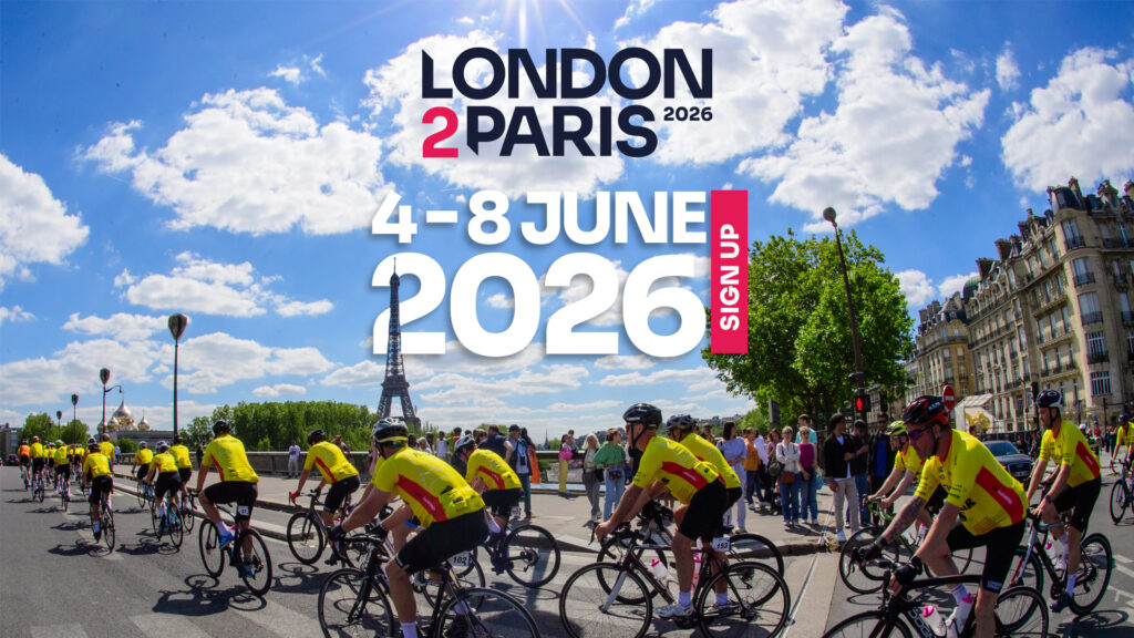 London 2 Paris 2026 with Cure Leukaemia. Riders looking happy riding in peloton through french street.