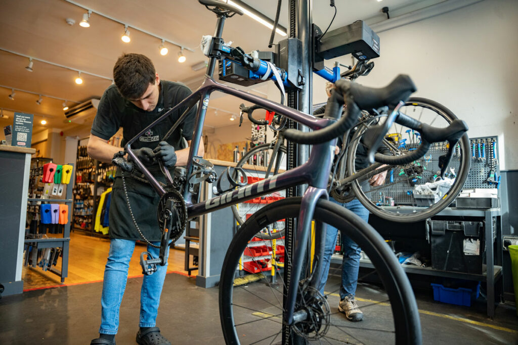 bike mechanic working on a giant bicycle in a balfes bikes shop