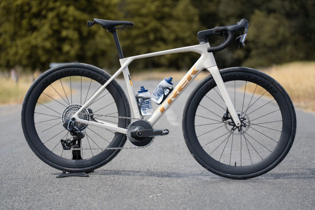 New Trek Domane SL Gen 5 in a cream and gold colour way with black components. Drivetrain side facing the camera.
