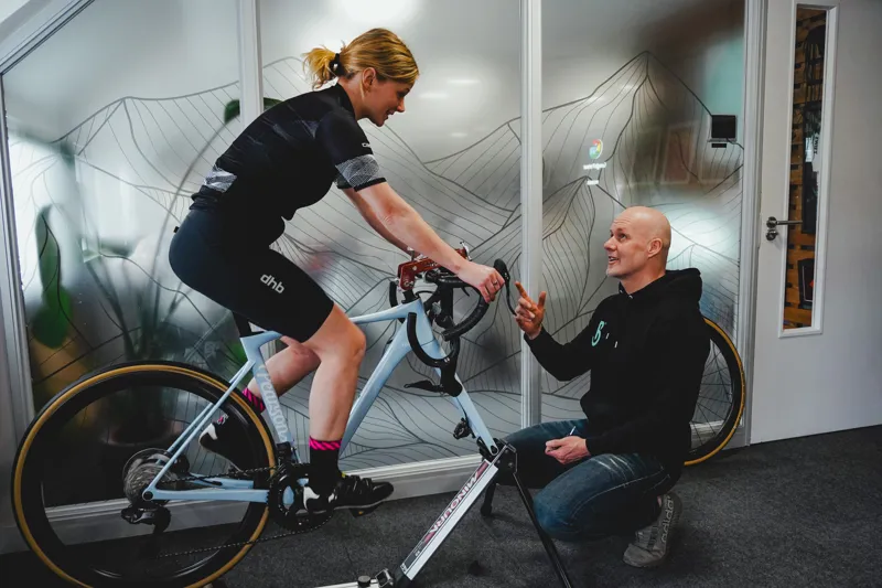 A professional bike fit taking place at a customer's home