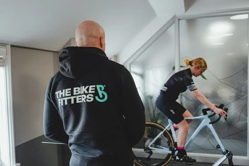 Bike fitter making precision adjustments to a customer's bike